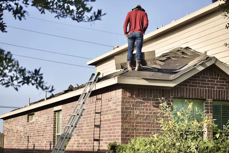 Professional roofer working on a residential roof in North Elba